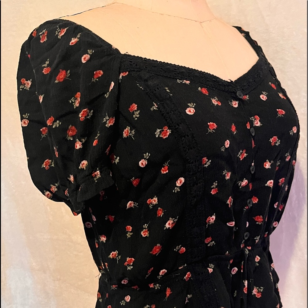 A floral blouse with red and pink flowers